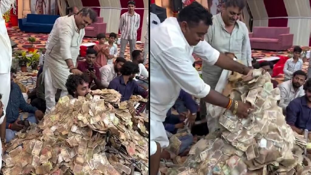 watch:-bhajan-singer-buried-under-cash-during-gujarat-event,-viral-video-sparks-debate-online